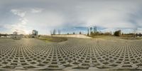 360 - pane of a concrete sculpture with geometric pattern in front of it and a large building in the background