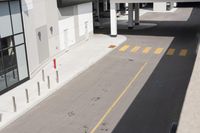 the view from the window of a parking garage showing yellow markings on a street and a red sign