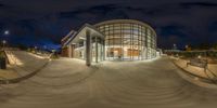 a fisheye view of the entrance to a library at night time of coursey photography