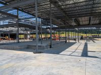 a very large building with many beams and buildings in the background for work on the construction