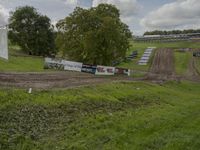 a dirt bike track with various stages coming off it, and a sign for motor sport