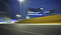 a blurred photograph of a street with buildings at night in the background for use as a wallpaper
