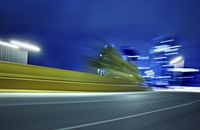 a blurred photograph of a street with buildings at night in the background for use as a wallpaper