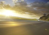 a motorcycle rider riding on an empty road at sunset time with motion blurry and sun shining down on the road