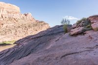 a group of men are walking along a path in a rocky area next to some rocks