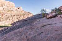 a group of men are walking along a path in a rocky area next to some rocks