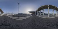 360 - panorama image with view of several buildings and poles on the ground and the sky