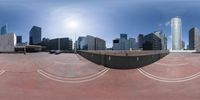 the image shows a wide angle view of an empty walkway with skyscrapers in the background