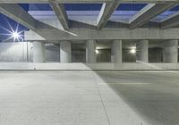 an empty parking garage with no people in it at night time time with only one stop sign