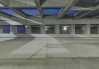 an empty parking garage with no people in it at night time time with only one stop sign