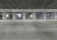 an empty parking garage with no people in it at night time time with only one stop sign