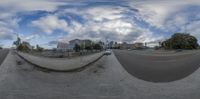 this is a fisheye view of a street corner with vehicles coming to the end