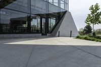 the building has glass and has an outside patio area with stone steps to the floor