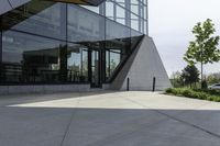 the building has glass and has an outside patio area with stone steps to the floor