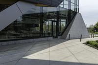 the building has glass and has an outside patio area with stone steps to the floor