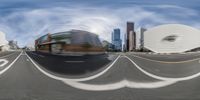 a blurry picture of the intersection with a red fire hydrant and buildings in the background