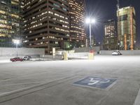 an empty parking lot at night surrounded by buildings and cars in a parking area at a business district