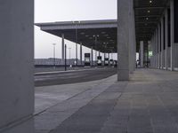 there is a view of an airport terminal from the outside, with some buses parked behind them