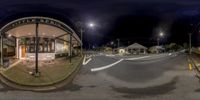 a 360 - view photo of a street corner with a stop sign, buildings and a street light