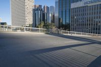 a paved street is in the city near tall buildings and trees on the side of the road
