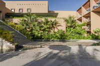 an open courtyard with a water feature and many palm trees beside the swimming area in a hotel building