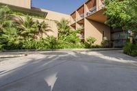 an open courtyard with a water feature and many palm trees beside the swimming area in a hotel building