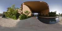 a circular picture shows the view of a pool and the entrance of the building and yard