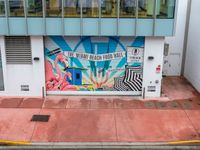 the entrance to an ice cream shop with a mural on the outside wall of it