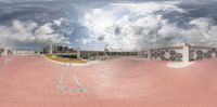 a view from a fish - eye lens of a skate park and buildings and buildings