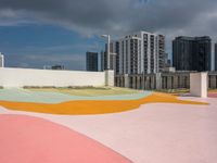 colorful playground on the rooftop with urban buildings in the background and a street sign at one end