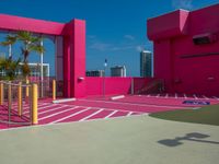 the building is bright and vibrant pink in color, the architecture is as if by the outside world