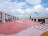 an empty parking lot has been painted red and yellow in the middle of a cloudy day