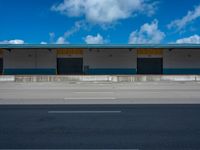 an empty lot with an empty parking lot in the background and clouds in the distance