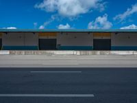 an empty lot with an empty parking lot in the background and clouds in the distance