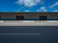 an empty lot with an empty parking lot in the background and clouds in the distance