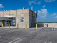 a parking lot with an air conditioning unit in the background and some clouds in the sky