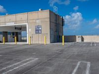 a parking lot with an air conditioning unit in the background and some clouds in the sky