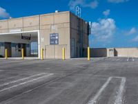 a parking lot with an air conditioning unit in the background and some clouds in the sky