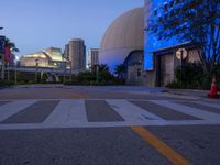 a building with large dome and sky in the background at night, including blue light