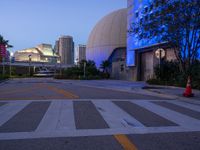 a building with large dome and sky in the background at night, including blue light