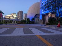 a building with large dome and sky in the background at night, including blue light