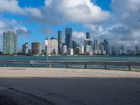 a man riding his bike near the water by himself on a windy day in miami