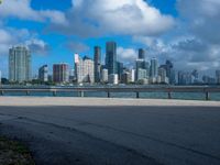 a man riding his bike near the water by himself on a windy day in miami