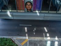 a woman looking out of a window at a street sign and building with colorful lights