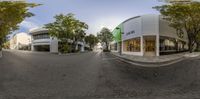 a 360 view of an outdoor store on the road near other buildings in the area