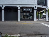 a small business in a city on the street corner with signs on it that read,'heritage henge '