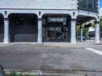 a small business in a city on the street corner with signs on it that read,'heritage henge '