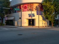 a street scene with focus on the corner and a traffic light on it's pole