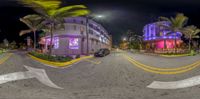 a fisheye view of the streets of this city at night with a building on the side