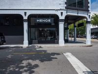 a small business in a city on the street corner with signs on it that read,'heritage henge '